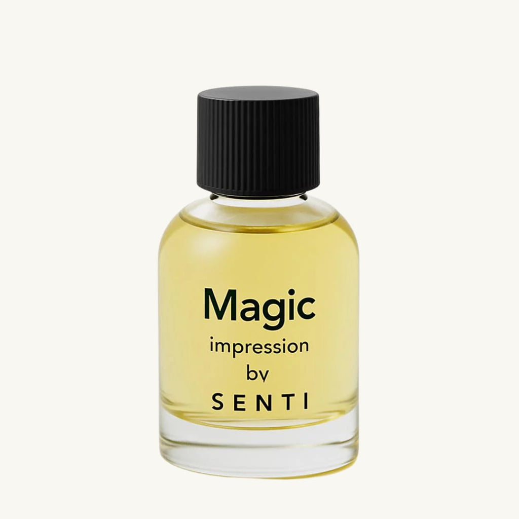 A single clear glass bottle of Senti Magic Impression perfume, featuring a black ridged cap and yellow-tinted liquid, against a clean off-white background.